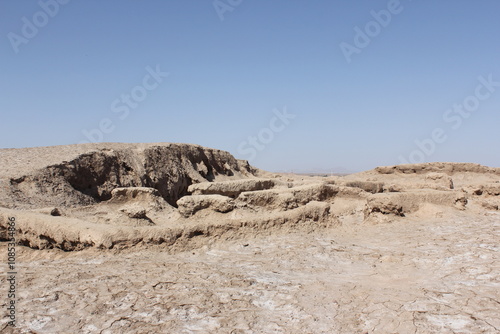 Stone ruins in an arid desert landscape, highlighting the historical significance and architectural prowess of ancient builders.