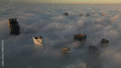 Aeril view of Warsaw city center and skyscrapers covered by fog during sunrise. photo