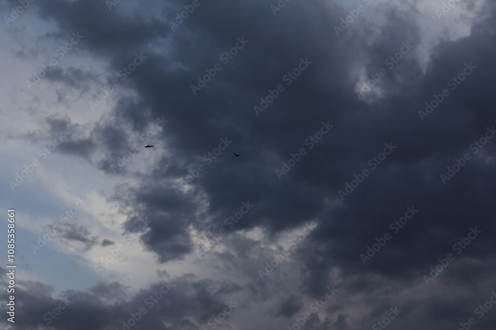 A moody sky with dark clouds, portraying nature�s intensity and serene mystery. A moody sky with dark clouds, portraying nature�s intensity and serene mystery.