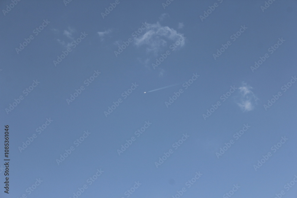 Empty blue sky with few small clouds, perfect for minimalist and clean natural backgrounds in photography. Empty blue sky with few small clouds, perfect for minimalist and clean natural backgrounds in photography.