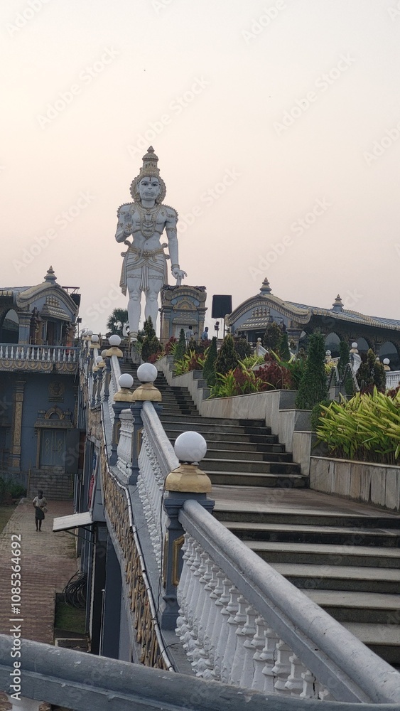 Fototapeta premium Vizianagram, Andhra Pradesh India - Oct 31 2024: Evening View of Ramanaraynam or Ramnaraynam at the modern construction of Rama's Bow and Arrow,statue of Lord Hanumana, goddess Saraswati and Lakshmi .