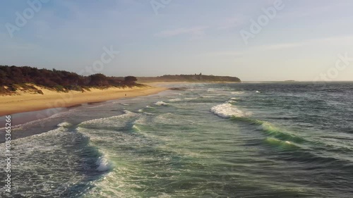 Aerial panorama of Caves beach sand dunes and waterfront from waves surf as 4k.
