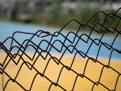 Close-up of twisted wire fence outdoor sports court photography urban environment ground level abstract concept photo