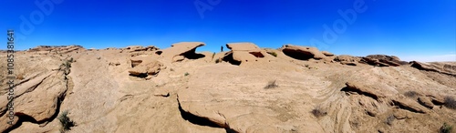 A stunning view of a desert landscape with red rock formations under a bright blue sky, perfect for travel photography and nature enthusiasts.