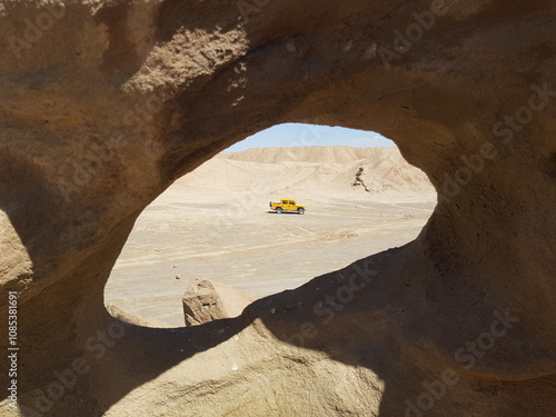 A close-up view of a natural desert arch, emphasizing the smooth, curved sandstone features shaped by time and nature.