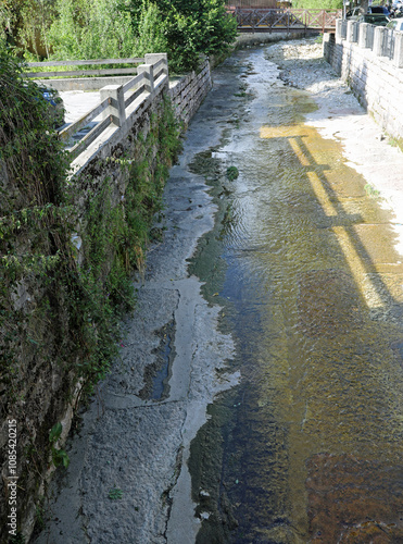 dry drainage channel to divert water during rain to avoid flooding in the city photo