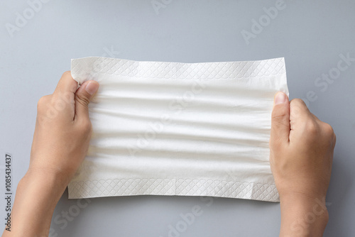 pull a paper napkin made of wood pulp with both hands.