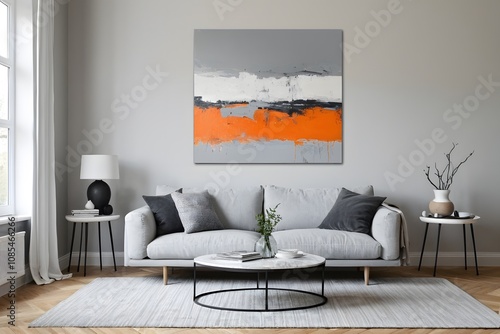 Grey modern living room with an orange-tone abstract painting. photo