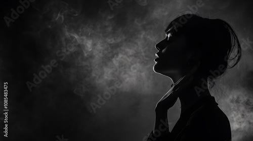 A dramatic silhouette of a woman against a smoky background, evoking a sense of mystery and introspection.