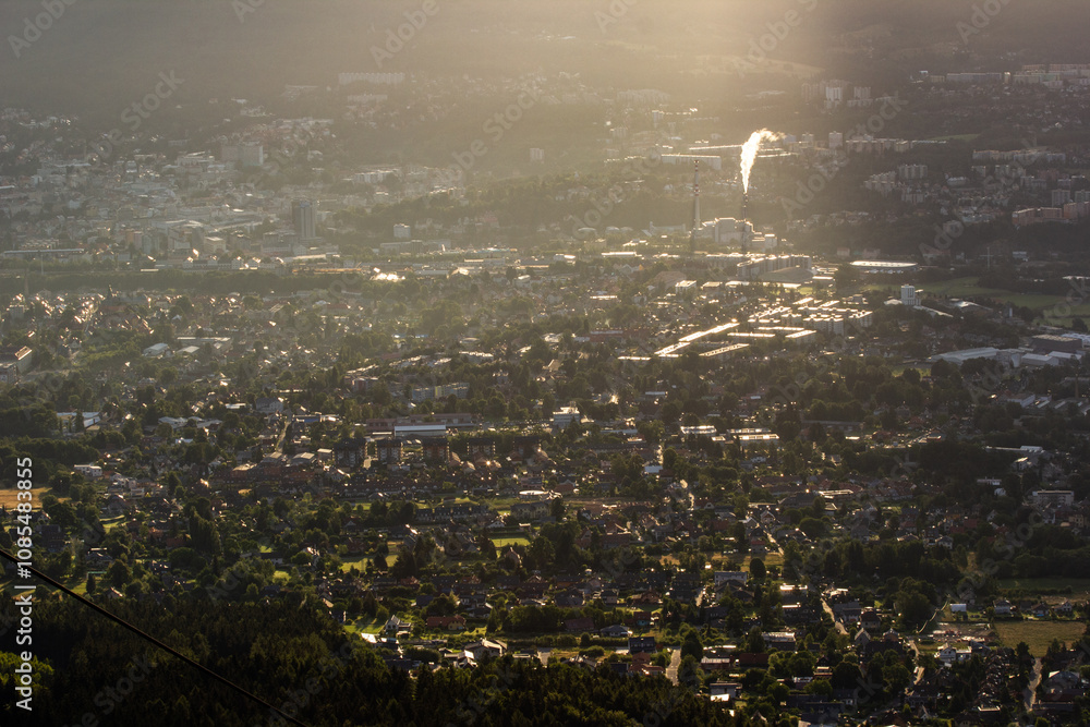 A ray of dawn falls on an industrial town in the mountains