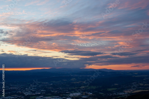 dawn against the backdrop of mountains and a small town