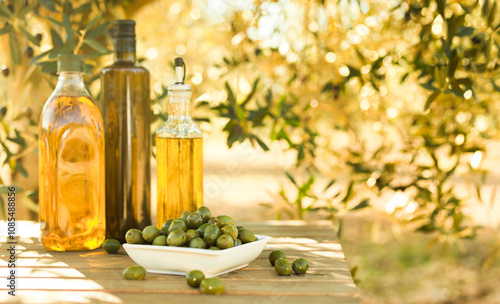 Green olives and oil on table in olive grove