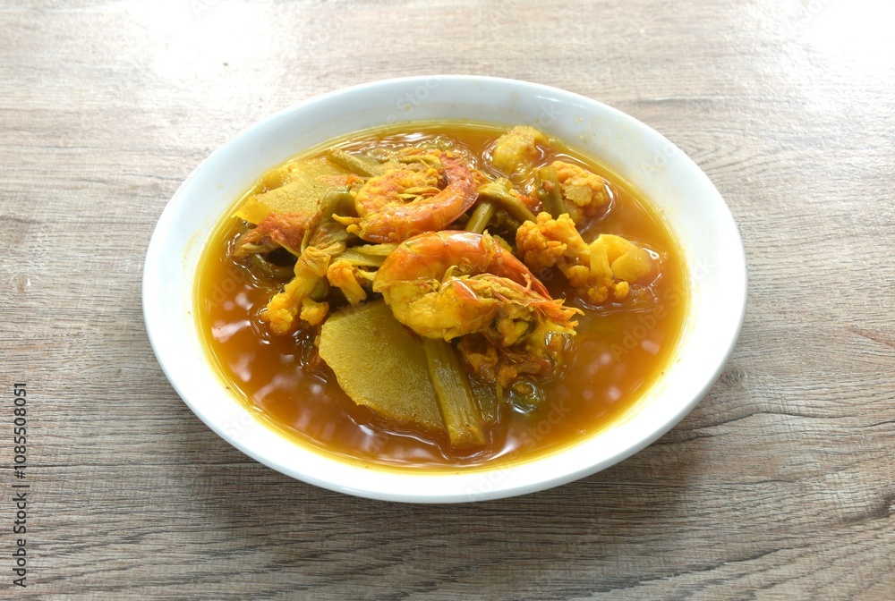 boiled shrimp and mixed vegetable in spicy and sour orange curry soup on plate boiled shrimp and mixed vegetable in spicy and sour orange curry soup on plate