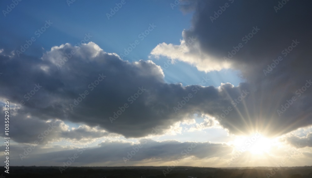 cloudy sky with sunlight breaking through in the distance cloudy sky with sunlight breaking through in the distance