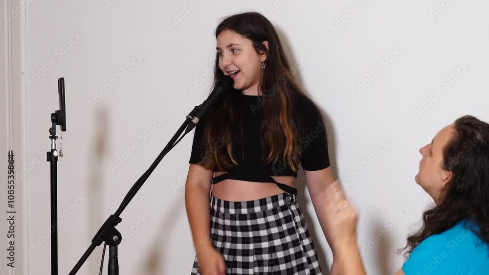Teenager girl has a vocal lesson with teacher playing piano Teenager girl has a vocal lesson with teacher playing piano