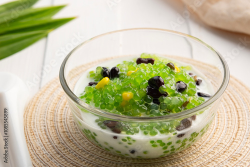 Pandan flavoured Black bean and corn Tapioca pearl pudding (Sago) with a dash of coconut milk,popular South-East Asian dessert in glass bowl