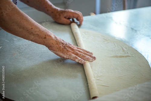 Elderly Woman Rolling Out Dough photo