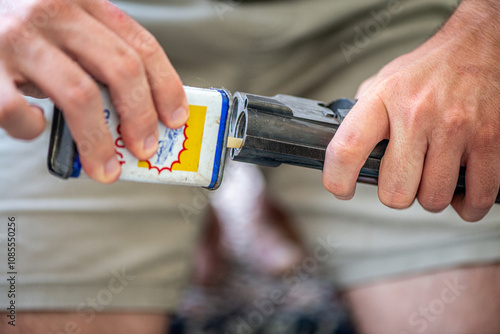 Man Cleaning an Old Rifle with Bare Hands photo