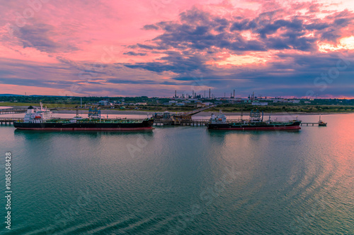 A view from Southampton water past tankers towards the Oil Refinery at Fawley at sunset in Autumn photo