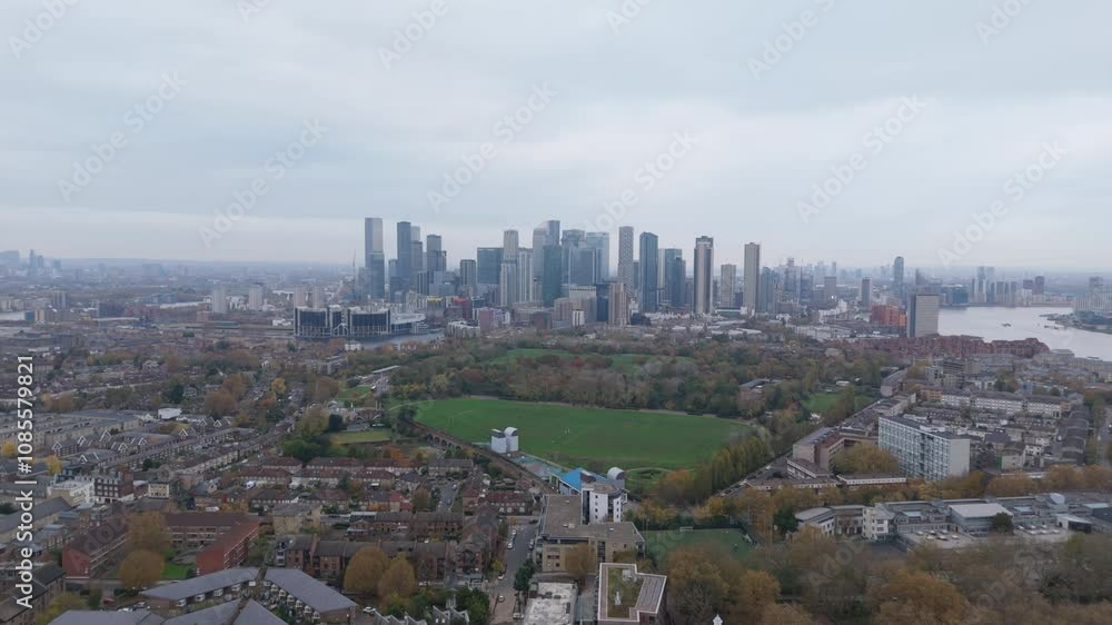 Aerial view of Canary Wharf skyline on the Isle of Dogs in London, United Kingdom. Business district on cloudy day. Aerial view of Canary Wharf skyline on the Isle of Dogs in London, United Kingdom. Business district on cloudy day.