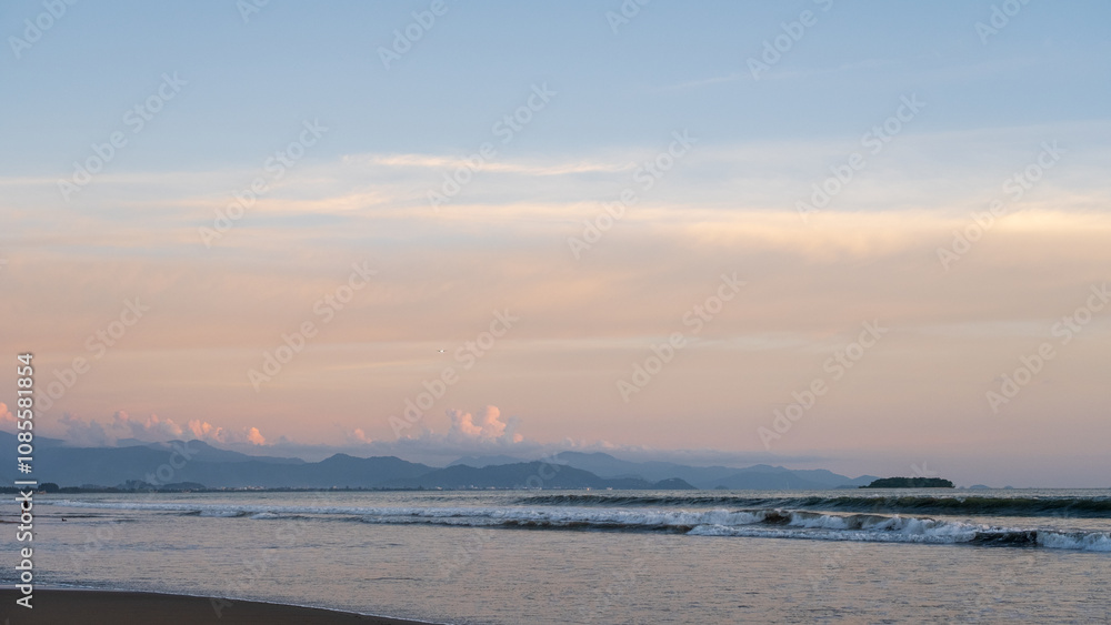 View of gentle waves on the beach with stunning afternoon sunlight, creating a serene tropical atmosphere. Perfect for travel, nature, and exotic Indonesian landscapes. View of gentle waves on the beach with stunning afternoon sunlight, creating a serene tropical atmosphere. Perfect for travel, nature, and exotic Indonesian landscapes.