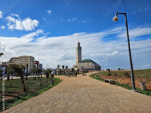 view of Hassan II Mosque against blue sky - The Hassan II Mosque or Grande Mosquée Hassan II is a mosque in Casablanca, Morocco. photo