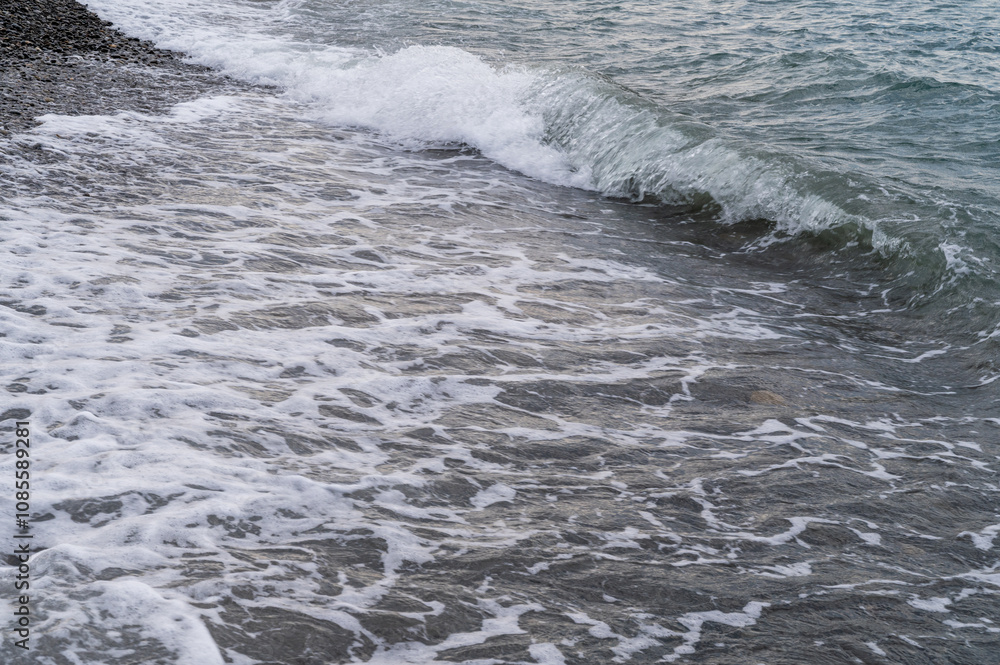 Fototapeta premium Water sea beach. Wave ocean blue. Stone texture reflection sun. Surface coast pebbles. 