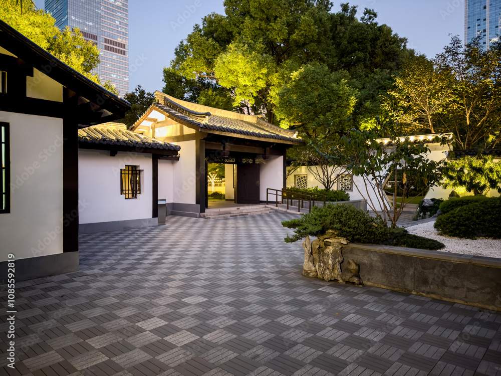 Fototapeta premium Serene Garden Pathway at Night Surrounded by Nature and Architecture