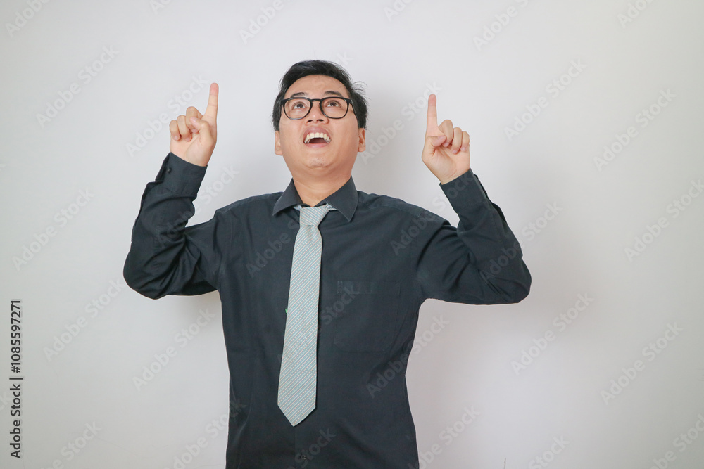 asian office man wearing black shirt pointing up, office man concept. asian office man wearing black shirt pointing up, office man concept.