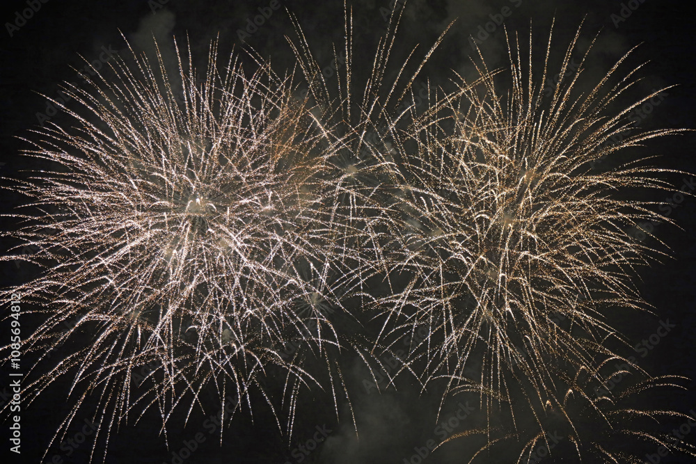 Obraz premium Fireworks exploding into two star bursts, Derbyshire England 