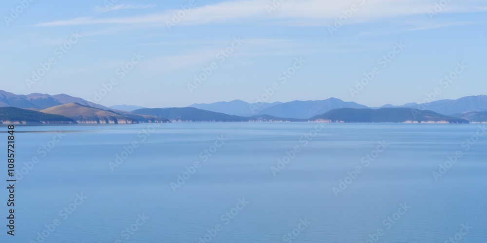 A panoramic view of rolling hills and a serene lake under a clear blue sky, panoramic, water, tranquil A panoramic view of rolling hills and a serene lake under a clear blue sky, panoramic, water, tranquil