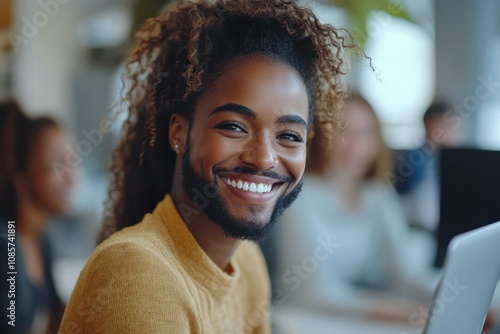 Smiling young woman with curly hair in cozy office setting engaging with colleagues during a productive workday in the afternoon photo