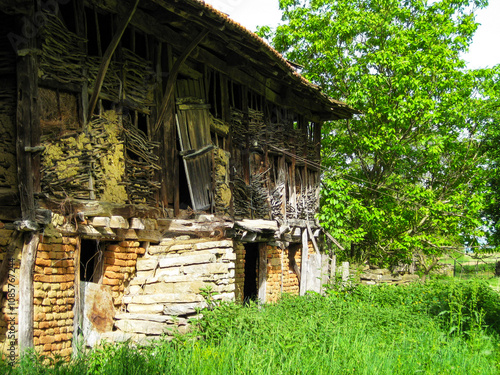 Old abandoned traditional barn in the Fore-Balkan village of Berievo, Gabrovo Province, northern central Bulgaria photo