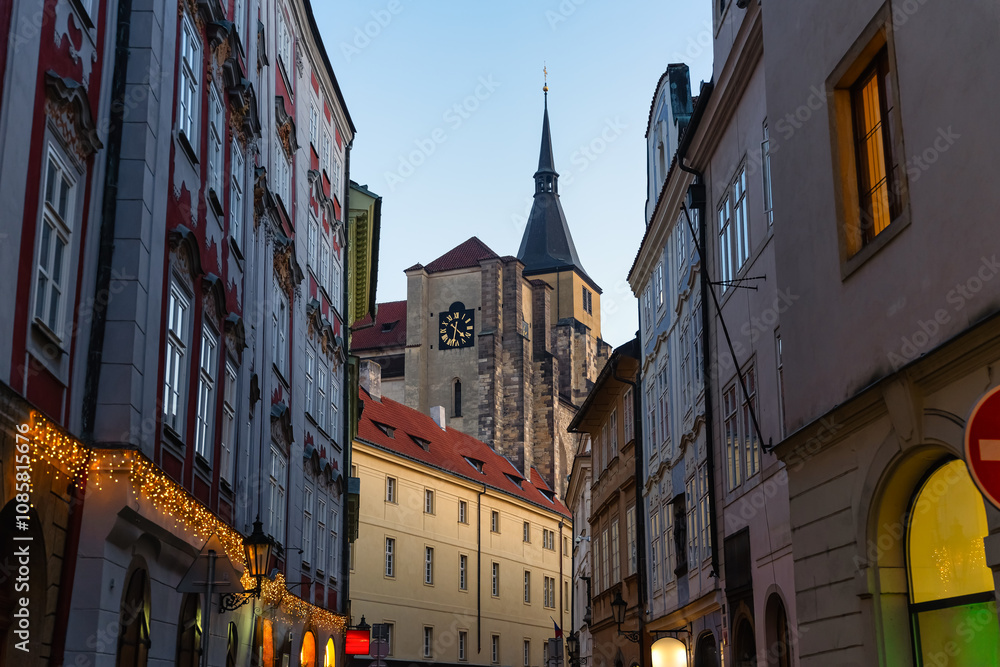 Fototapeta premium Streets and buildings of the medieval city of Prague at dusk with street lighting.