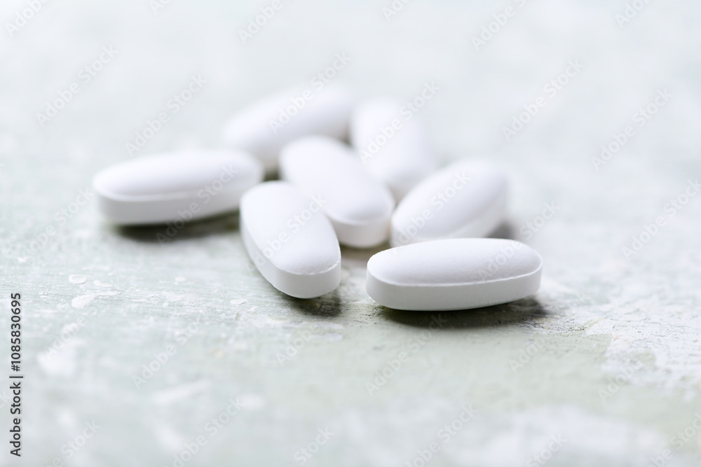White tablets on wooden background. Soft focus. Close up. Copy space White tablets on wooden background. Soft focus. Close up. Copy space