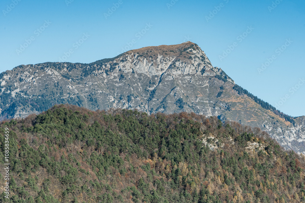Fototapeta premium Peaks of Friuli Venezia Giulia above Illegio: Mountain Landscape with Winter Colors and Clear Sky, Atmosphere of Peace and Tranquility.