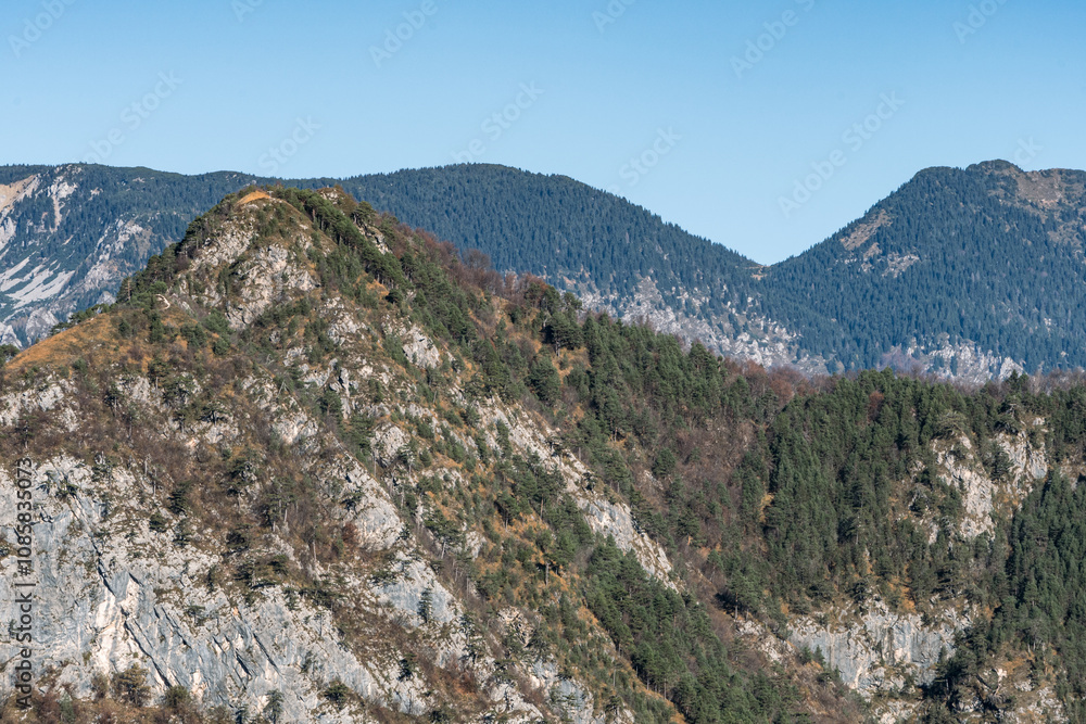 Peaks of Friuli Venezia Giulia above Illegio: Mountain Landscape with Winter Colors and Clear Sky, Atmosphere of Peace and Tranquility. Peaks of Friuli Venezia Giulia above Illegio: Mountain Landscape with Winter Colors and Clear Sky, Atmosphere of Peace and Tranquility.