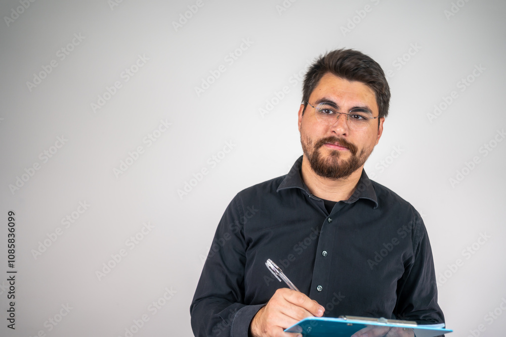 Sympathetic lawyer with a folder in hand. Happy man writing on a notepad, enjoying the moment. Smiling man writing with a pen, focused and happy. Sympathetic lawyer with a folder in hand. Happy man writing on a notepad, enjoying the moment. Smiling man writing with a pen, focused and happy.