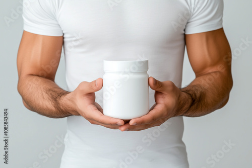 A man is holding a jar of something in his hand