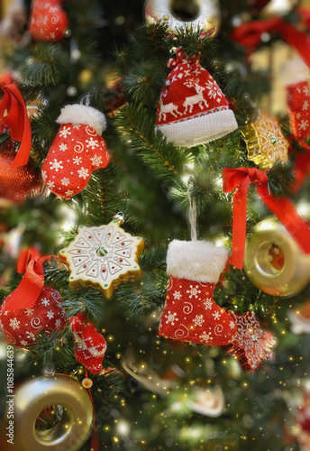 Christmas Tree with many of red ornaments. Knitted toy decorations.