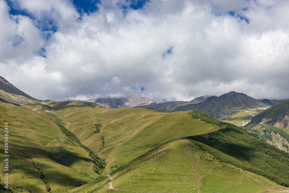 Caucasian mountains near Gergeti village, Stepansminda. Kazbegi mountain behind the clouds. Georgia