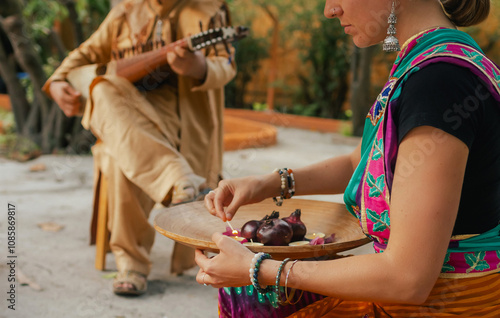 Photography Indian musician in traditional clothes playing sitar festive season outdoor home