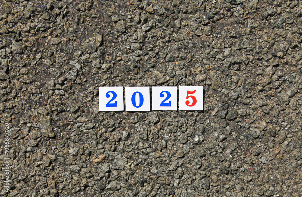 Numbers of 2025 year. Paper square numbers on the stone road background, that means coming New Year Eve. Christmas, holidays, celebration concept. New Year of 2025, year of green wooden snake Numbers of 2025 year. Paper square numbers on the stone road background, that means coming New Year Eve. Christmas, holidays, celebration concept. New Year of 2025, year of green wooden snake