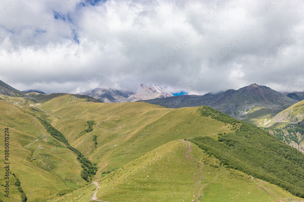 Caucasian mountains near Gergeti village, Stepansminda. Kazbegi mountain behind the clouds. Georgia