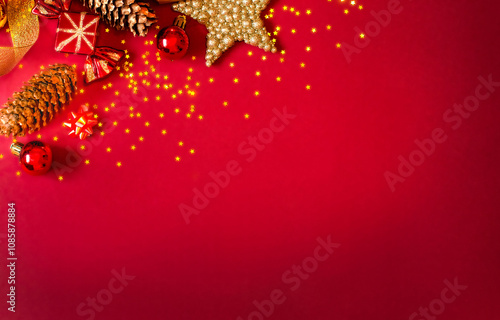Christmas card on a red background, gold and red Christmas tree decorations. Copy Space. High quality photo