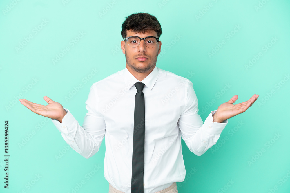 Business caucasian man isolated on blue background having doubts while raising hands