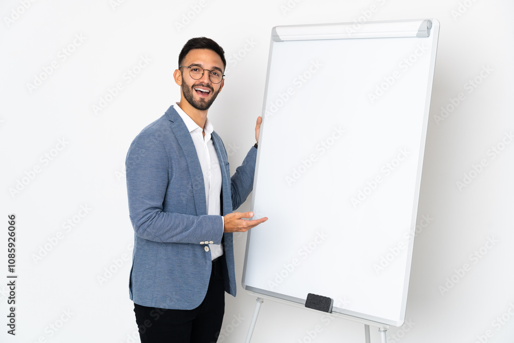 Young caucasian man isolated on white background giving a presentation on white board Young caucasian man isolated on white background giving a presentation on white board