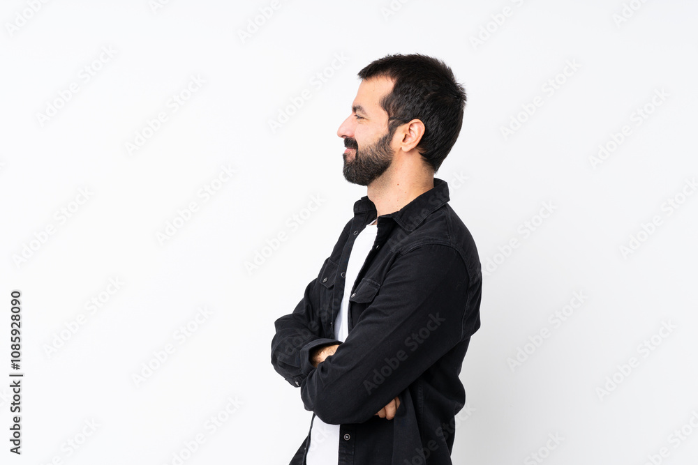 Young man with beard over isolated white background in lateral position Young man with beard over isolated white background in lateral position