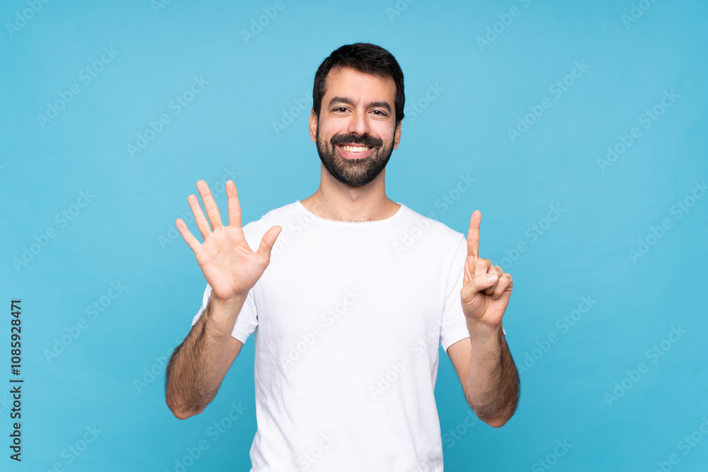 Young man with beard over isolated blue background counting six with fingers Young man with beard over isolated blue background counting six with fingers