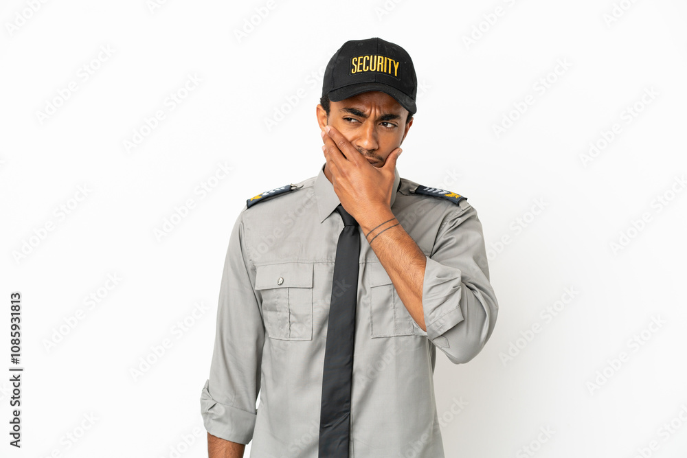 African American safeguard over isolated white background having doubts and with confuse face expression African American safeguard over isolated white background having doubts and with confuse face expression